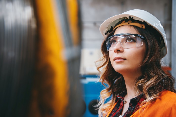 A PeoplePlus candidate and learner looks up to construction opportunity. 